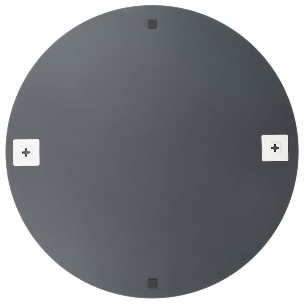 Round mirror hung in a hallway