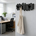 Black wooden wall coat rack with eight hooks